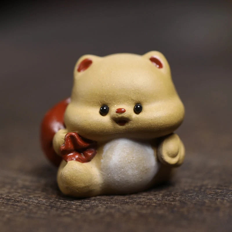Mascottes de thé mignon en argile